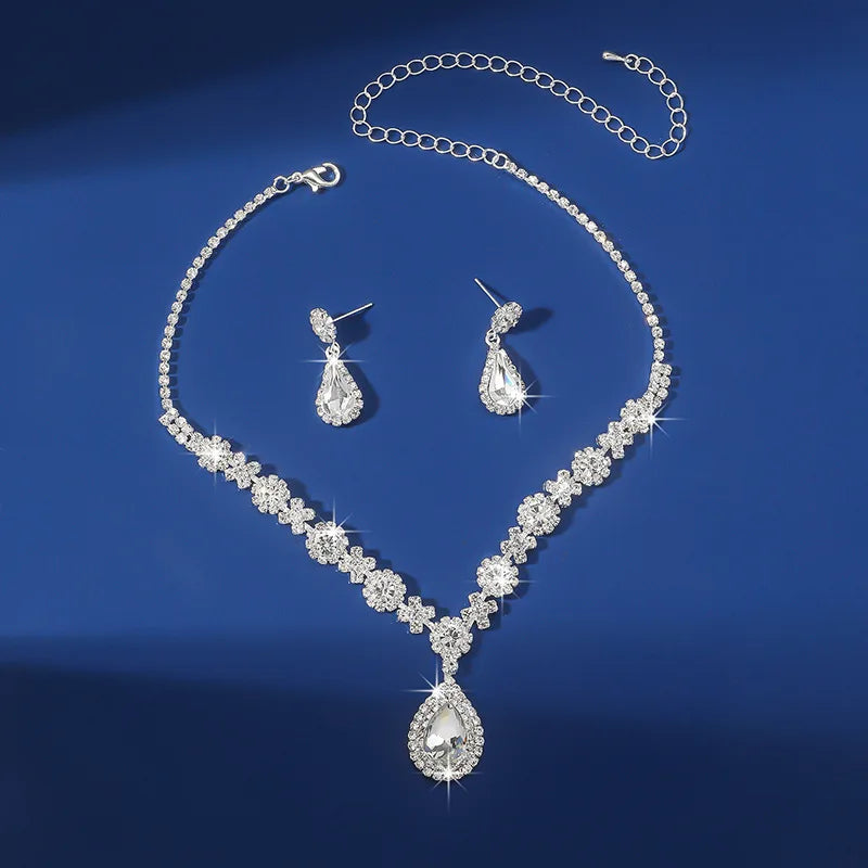 Elegant 2pcs waterdrop rhinestone jewelry set featuring a necklace and earrings on a blue background.